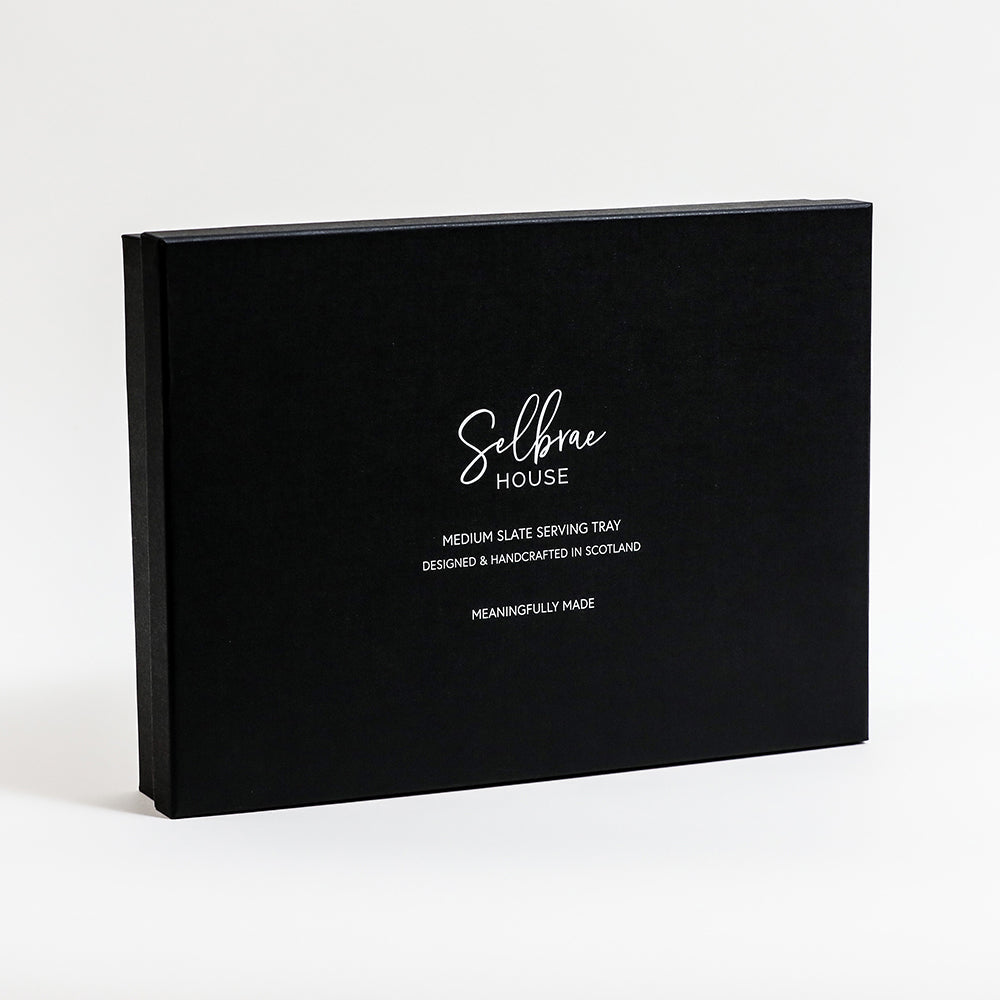 Black serving tray packaging box with branding and tray description.