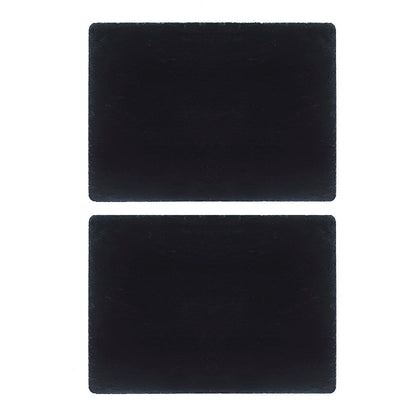 Two dark square slate place mats, flat matte surface