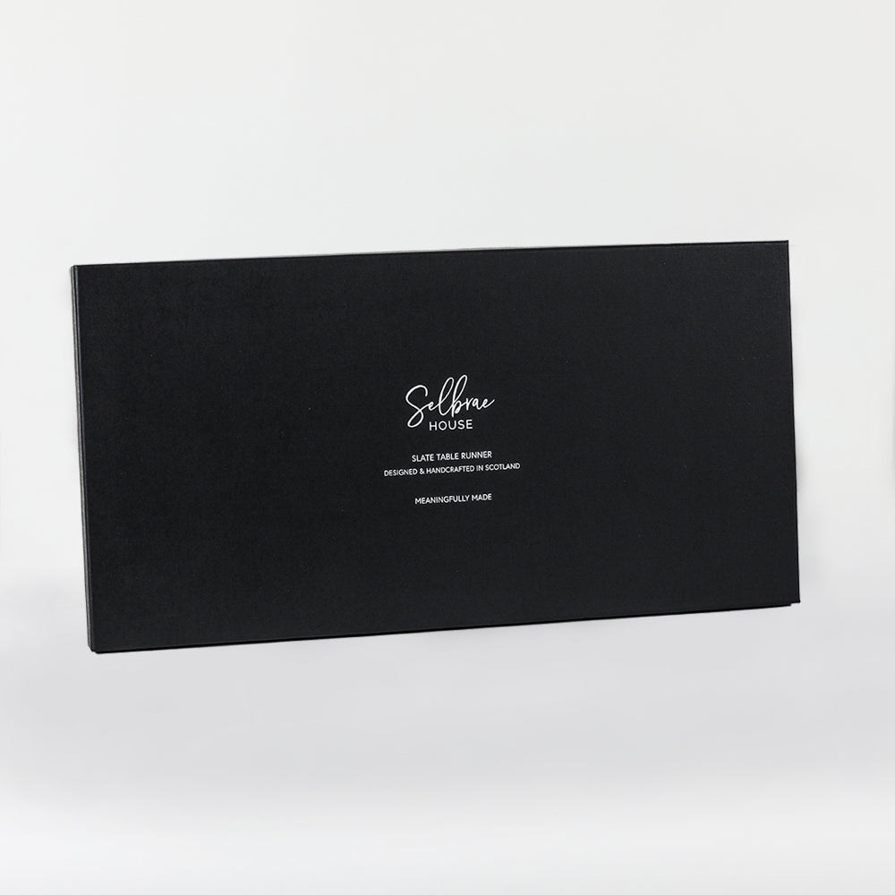 Slate table runner with white logo and design on black slate