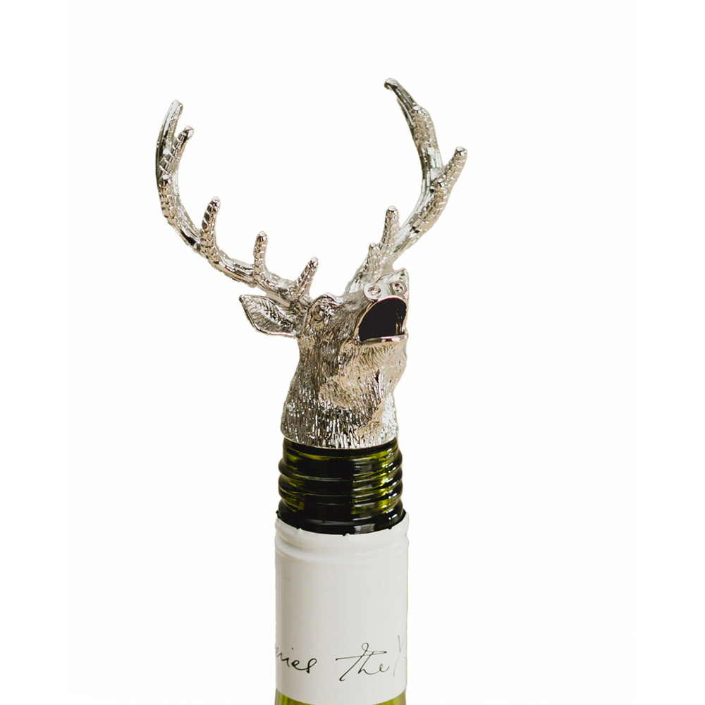 Antler-shaped stag bottle pourer attachment on a wine bottle neck
