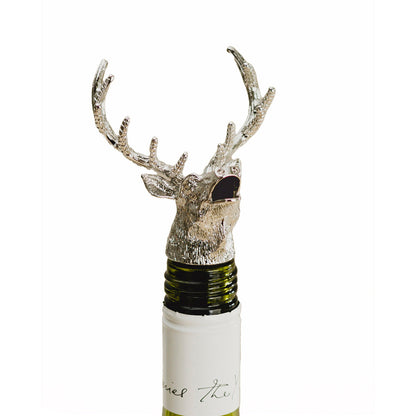 Antler-shaped stag bottle pourer attachment on a wine bottle neck