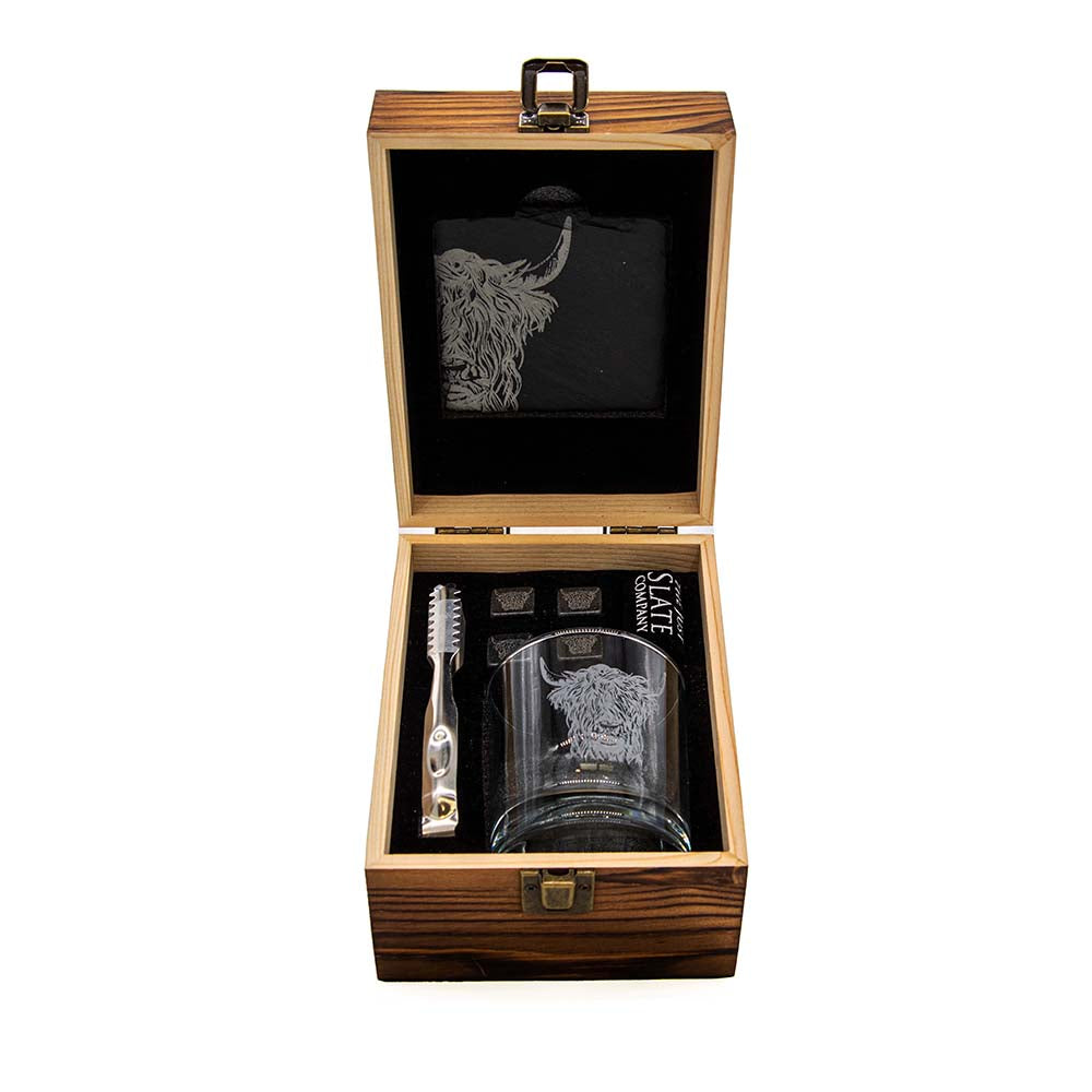 Opened wooden drinks set case with cow-etched glass, black pouch, and bar tools