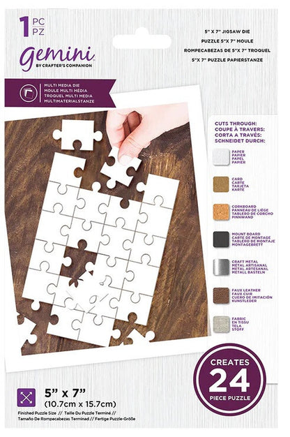 Gemini 1-piece 5x7 inch jigsaw puzzle packaging by Crafter's Companion, showing a hand placing a white puzzle piece on a wooden surface, with color options and product details printed on the card.
