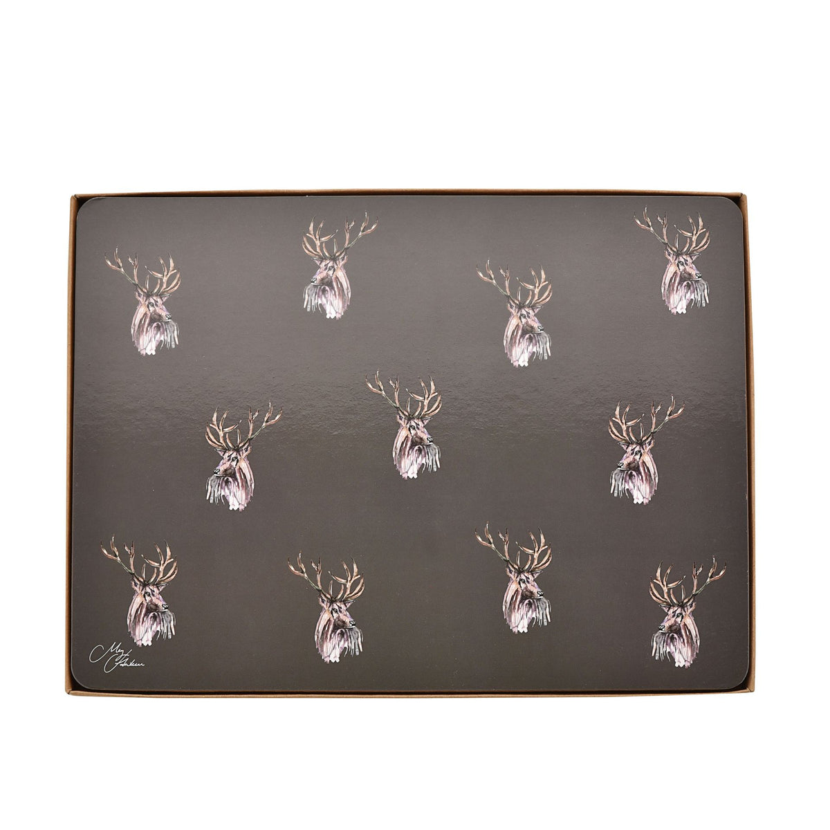 Boxed set of four dark placemats with repeating stag head motif in gold and white.