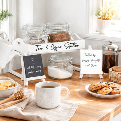 Tea and coffee station with jars, teapot, mugs, and chalk easel signs
