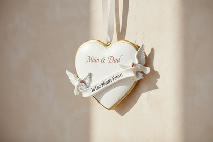 Heart-shaped ornament with two doves and 'In Our Hearts Forever' banner