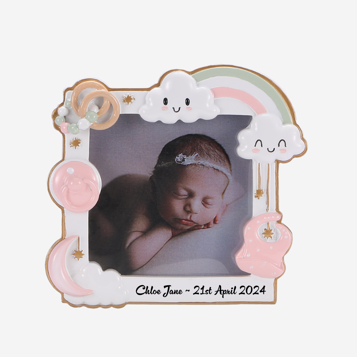 Personalized baby photo frame holding a photo of a sleeping newborn baby, with a pastel rainbow, smiling clouds, moon, sun, and baby imagery. The frame has the name 'Chloe Jane' and the date '21st April 2024' written at the bottom, 