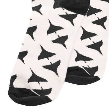 Lower-leg close-up of men's crew socks in white with black Vulcan-style triangle pattern