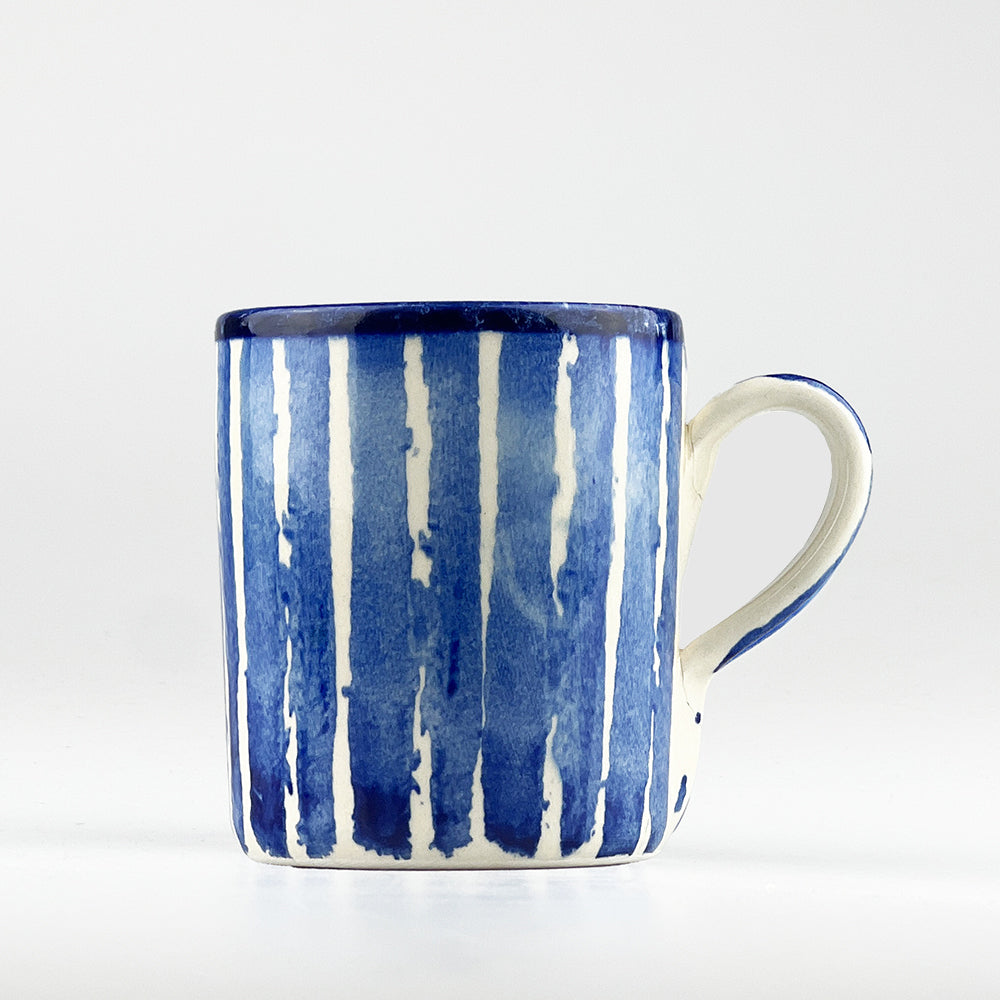 Blue and white striped ceramic mug with C-shaped handle, front view