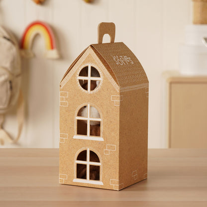 Brown cardboard dollhouse with three arched windows and a roof topper