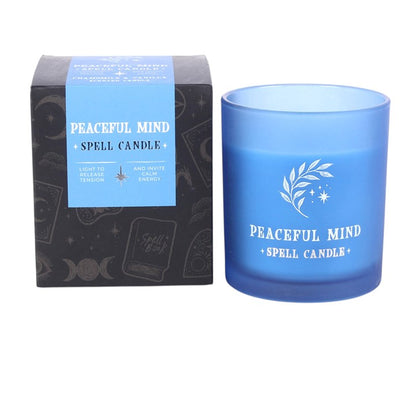 Blue scented candle in jar with "Peaceful Mind + Spell Candle" print and gift box