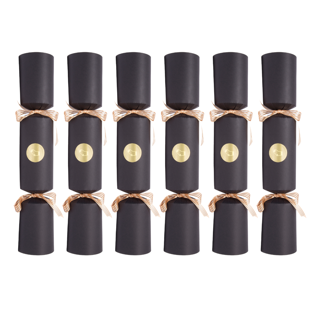 Six black cylindrical party crackers arranged in two rows on a plain white background, each tied with a metallic rose-gold ribbon and featuring a round gold emblem on the front.