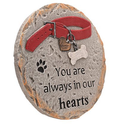 Pet memorial stone with red collar, heart tag, paw print, bone charm, “You are always in our hearts”.