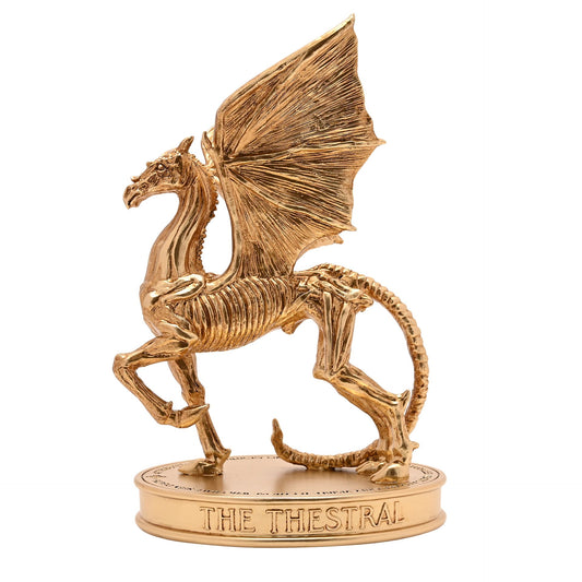 Gold Thestral figurine with wings spread, standing on round engraved base