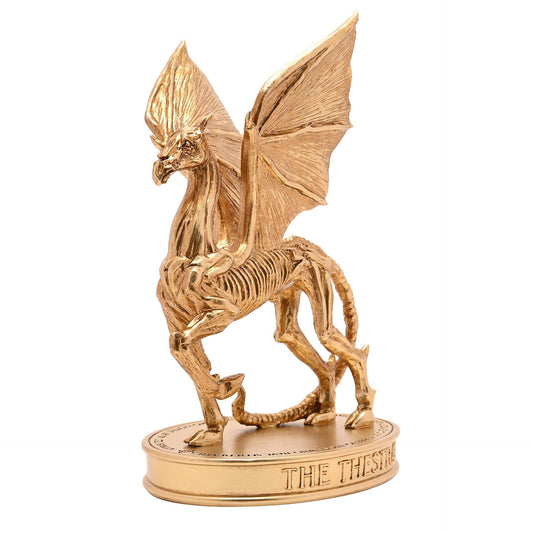 Gold Thestral figurine rearing with wings raised, on engraved circular base