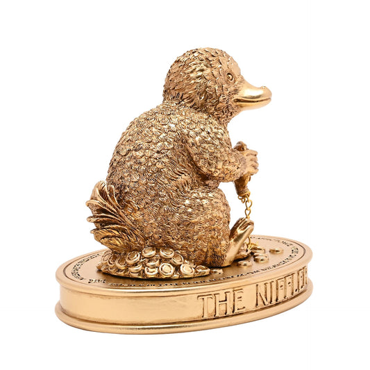 Right-facing Niffler figurine with textured fur, hanging chain on "The Niffler" base