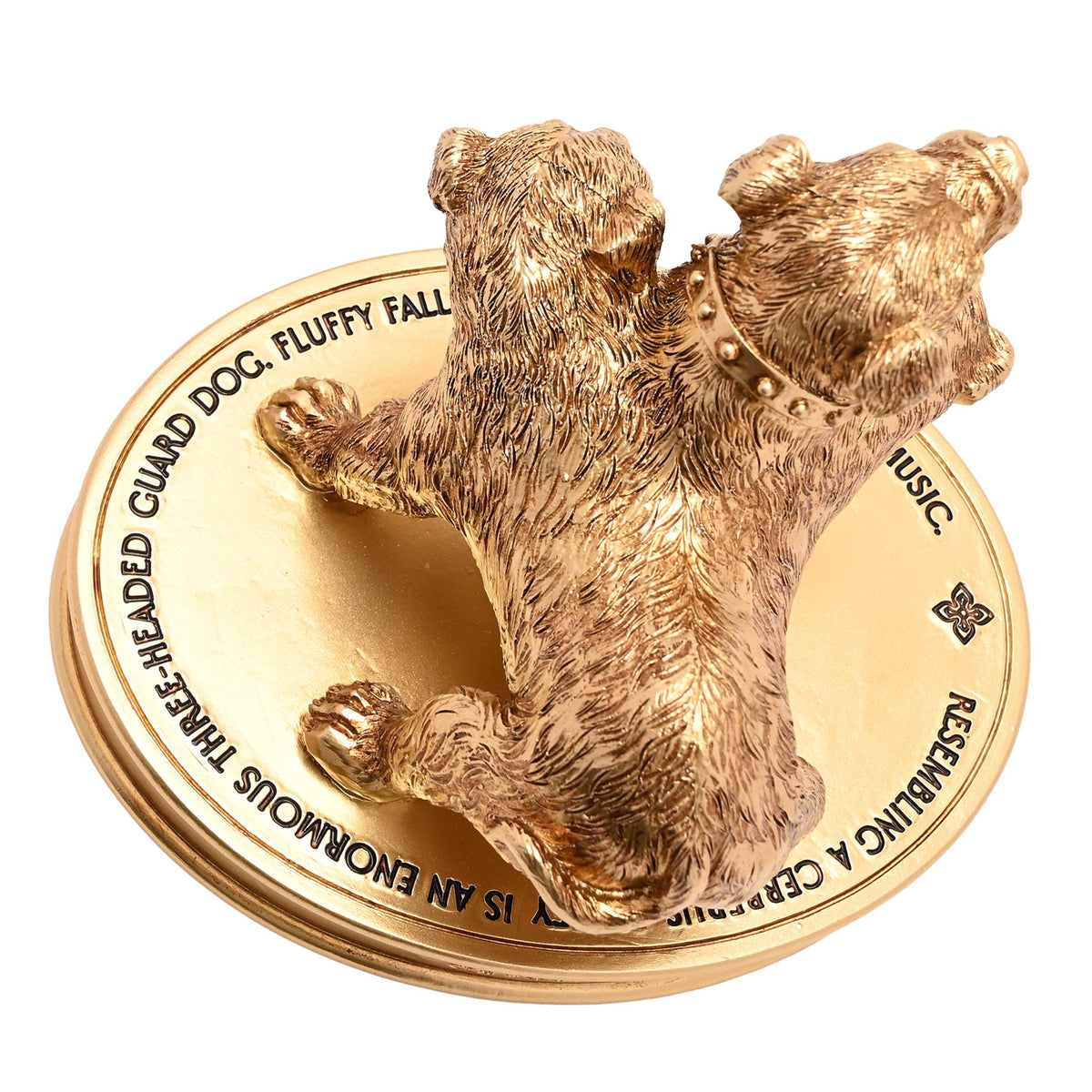 Gold three-headed dog figurine on detailed round base, “FLUFFY” text visible.