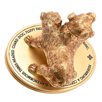Gold three-headed dog figurine on detailed round base, “FLUFFY” text visible.