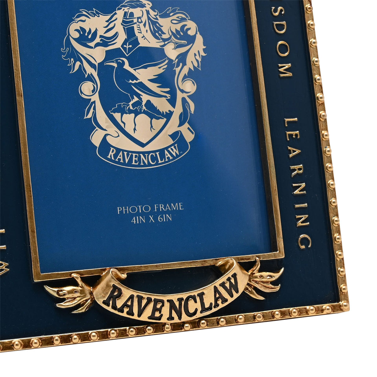 Close-up Ravenclaw crest photo frame with blue inner art and gold “LEARN WISDOM” text
