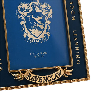 Close-up Ravenclaw crest photo frame with blue inner art and gold “LEARN WISDOM” text