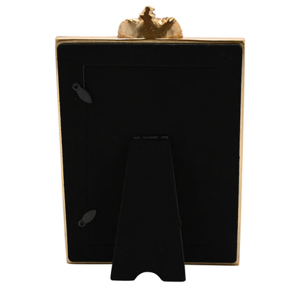 Back view of photo frame with black backing and gold top decorative crest
