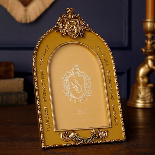 Golden arched photo frame with Hufflepuff crest and decorative scrollwork
