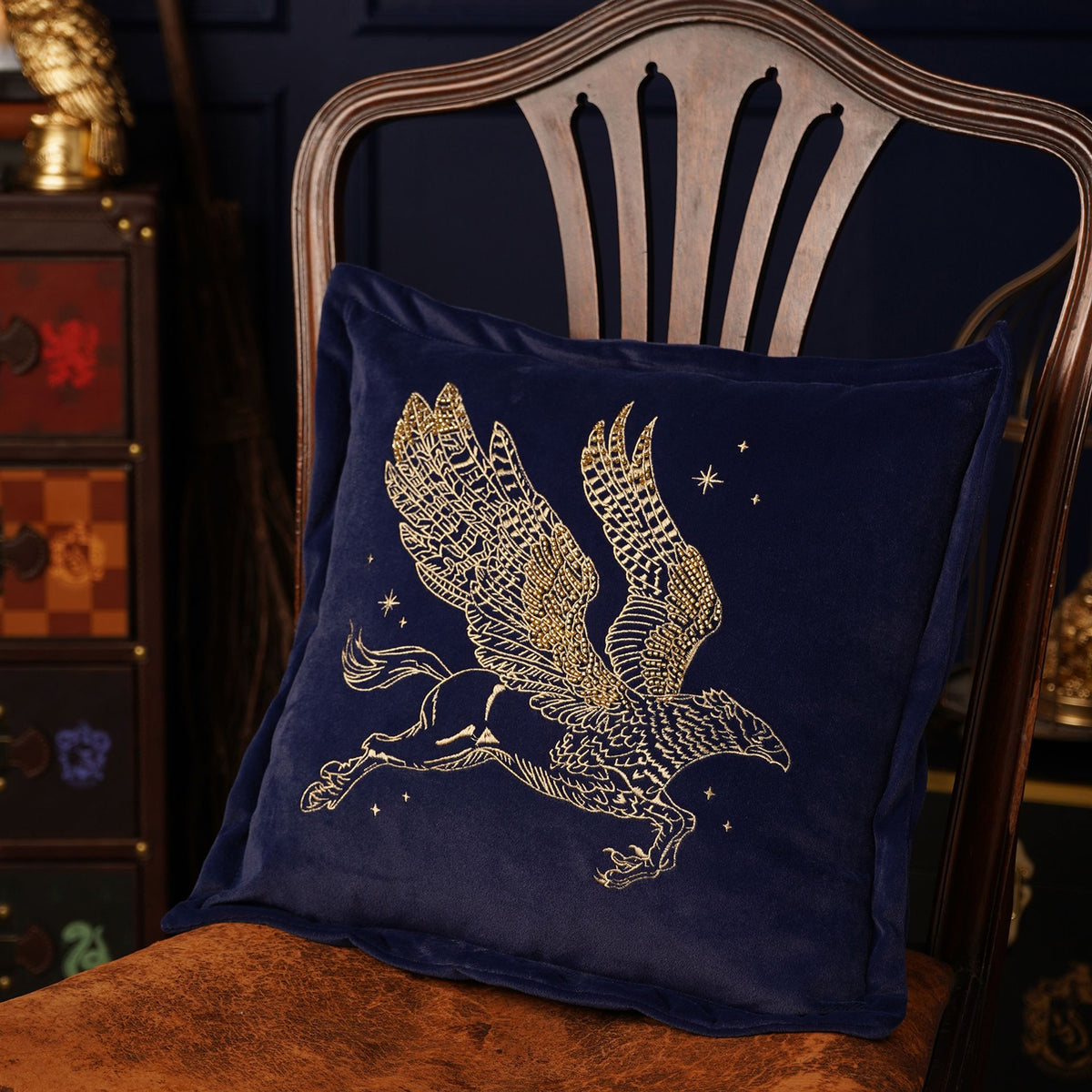 Harry Potter Buckbeak velvet cushion, navy with gold embroidered flying griffin motif