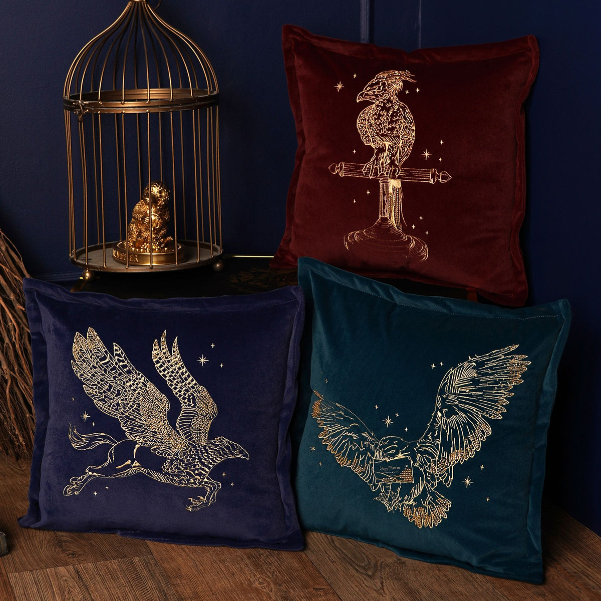Navy velvet Buckbeak cushion with gold embroidered griffin motif