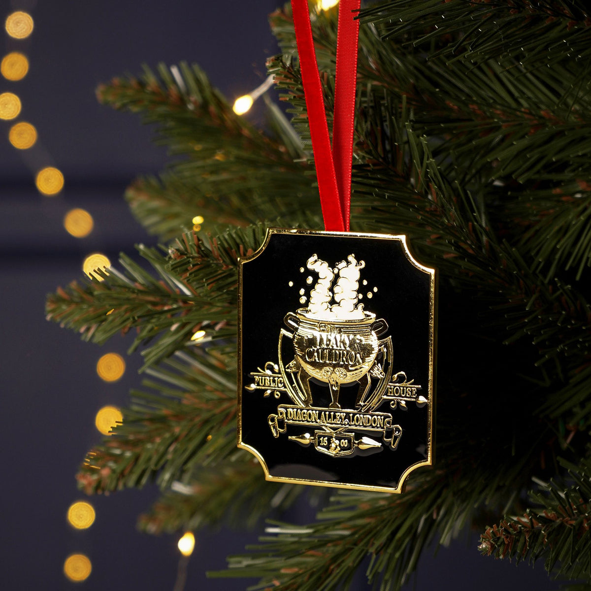 Leaky Cauldron metal hanging decoration with gold crest and red ribbon loop