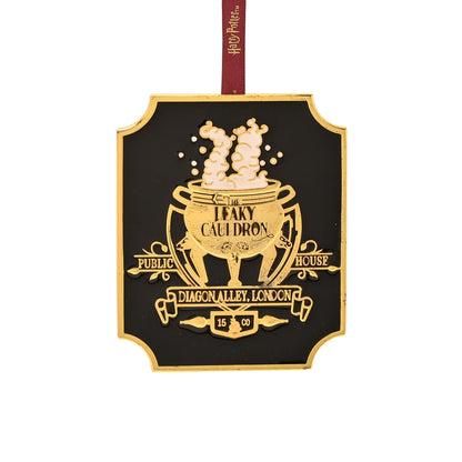 Black octagon hanging plaque with gold Leaky Cauldron graphic and red hanging ribbon