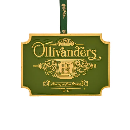 Green metal ornament with gold Ollivanders lettering and green hanging ribbon.