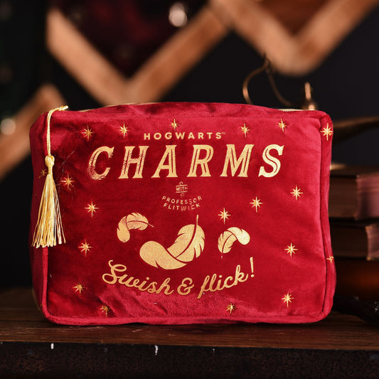 Red Hogwarts charms wash bag with gold print and tassel, front view