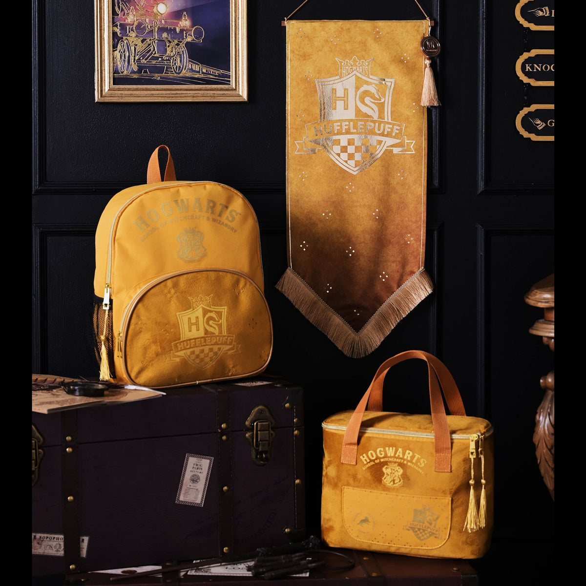 Hufflepuff hanging banner on wall with gold crest and tassel fringe on brown