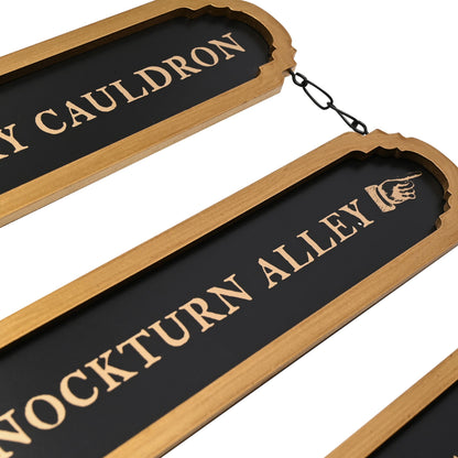 Close hanging wooden sign pair with Cauldron and Knockturn Alley text