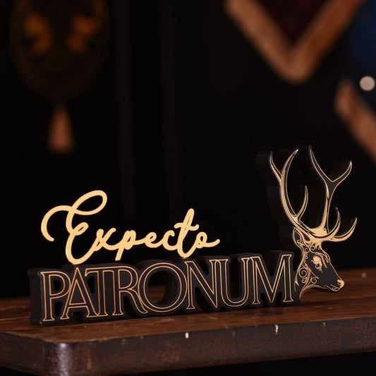 Expecto Patronum sign with gold stag antlers on dark wooden base