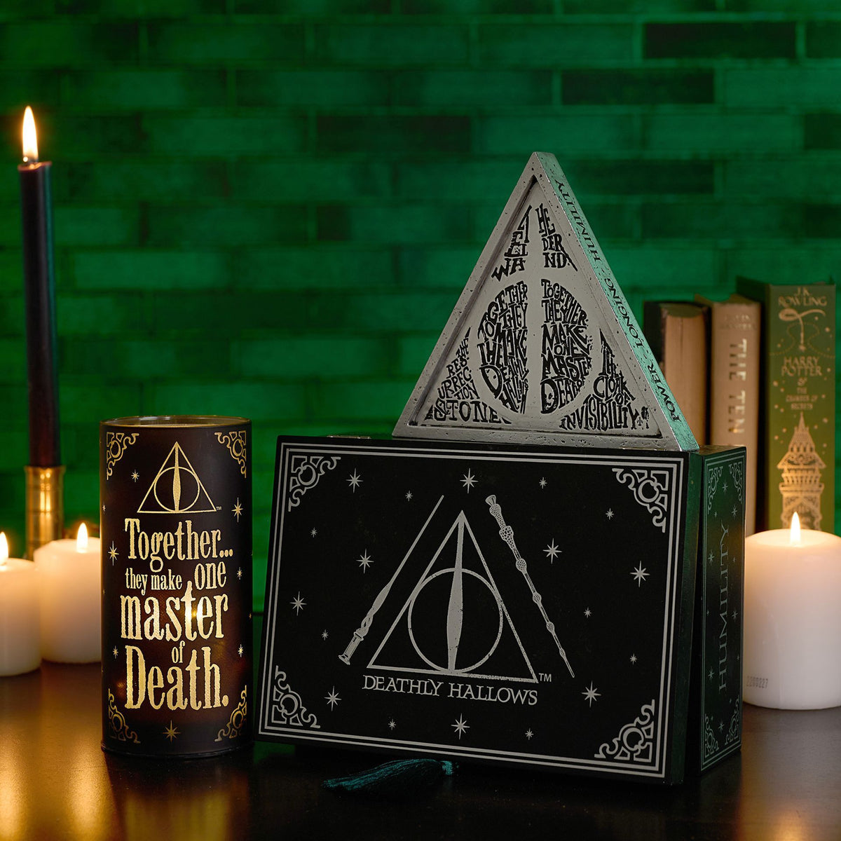 Black box with “Deathly Hallows” emblem, teal tassel, and “Together” candle nearby
