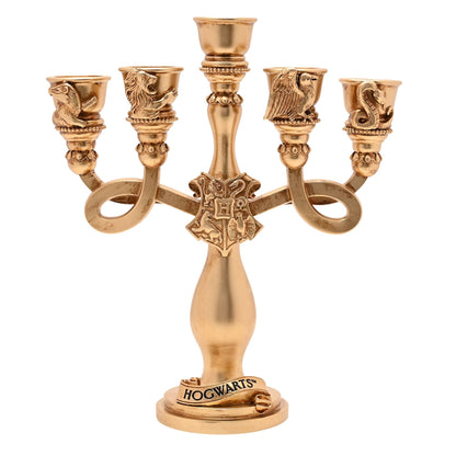 Gold-toned resin candelabra with five cup candle holders and Hogwarts emblem base