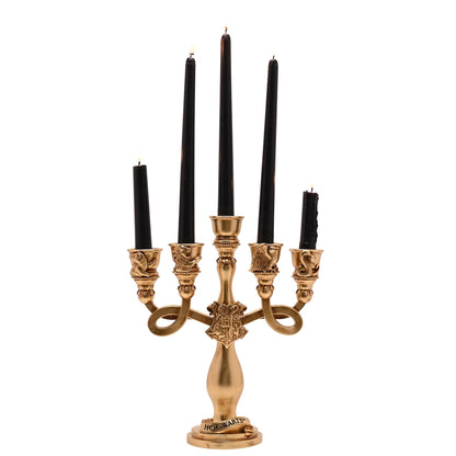 Gold-toned resin candelabra with five black pillar candles and Hogwarts crest base