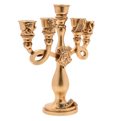 Gold-toned resin candelabra with five arms, central pedestal, and Hogwarts crest base