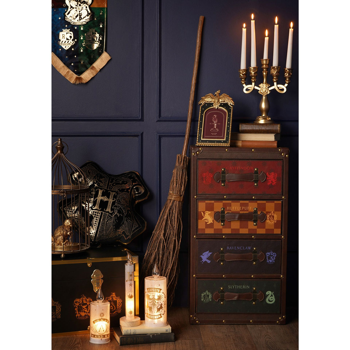 Gold-toned resin candelabra with five candles and ornate arms on a decorative base