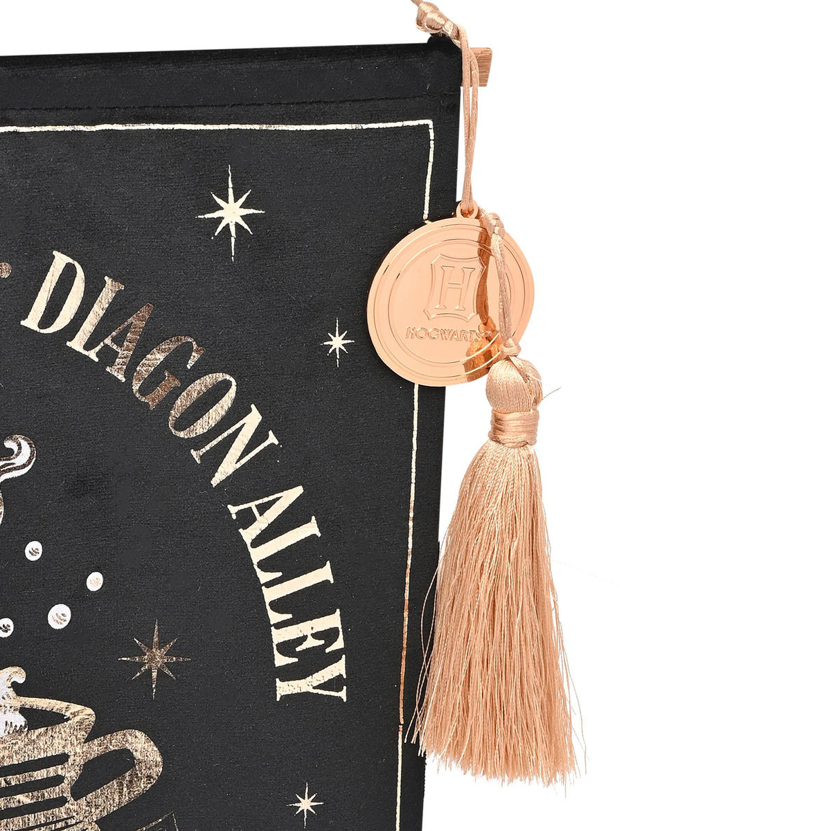 Close-up of black banner with gold lettering and stars, tan tassel and round charm