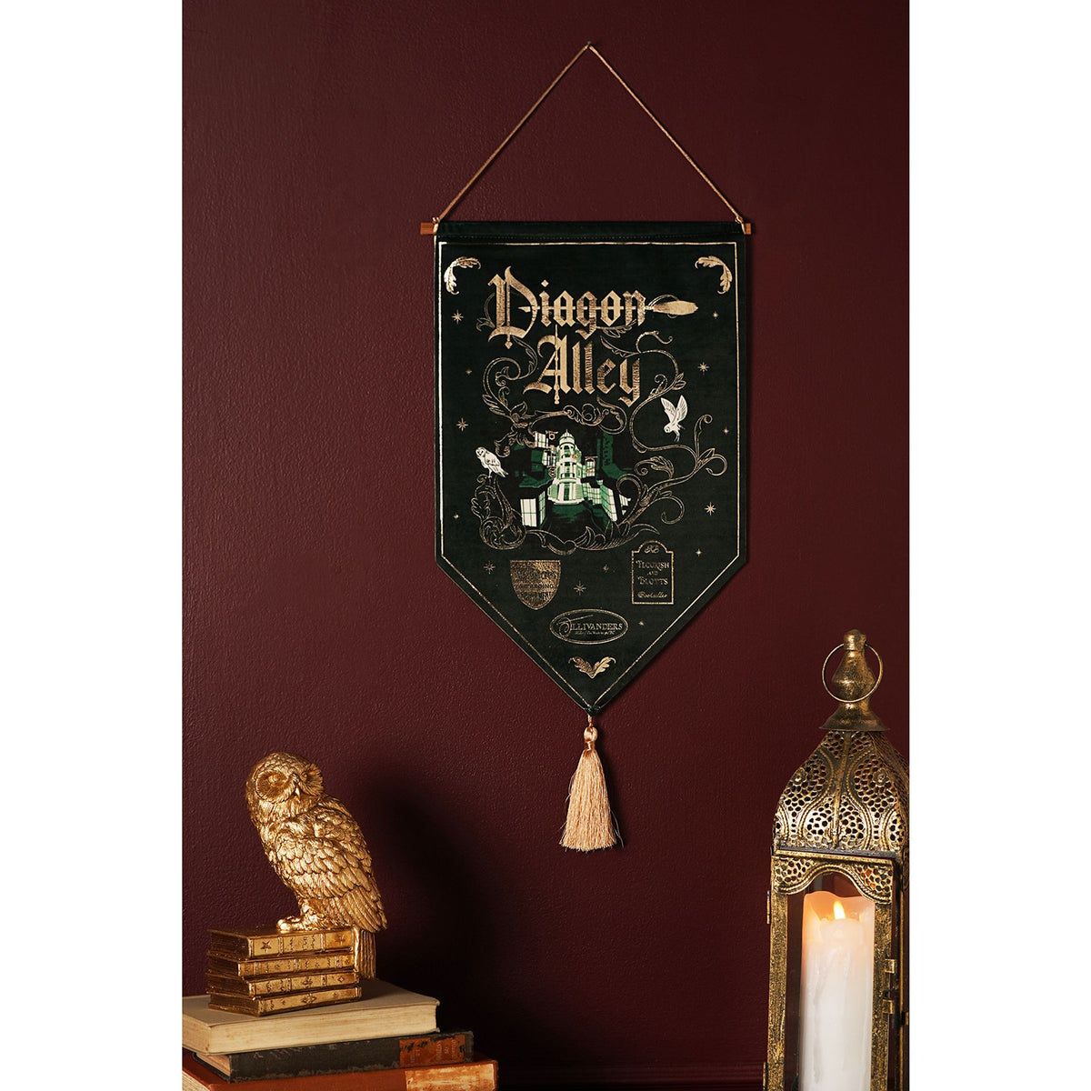 Hanging Diagon Alley banner with gold lettering and illustrated shop scene, tassel trim