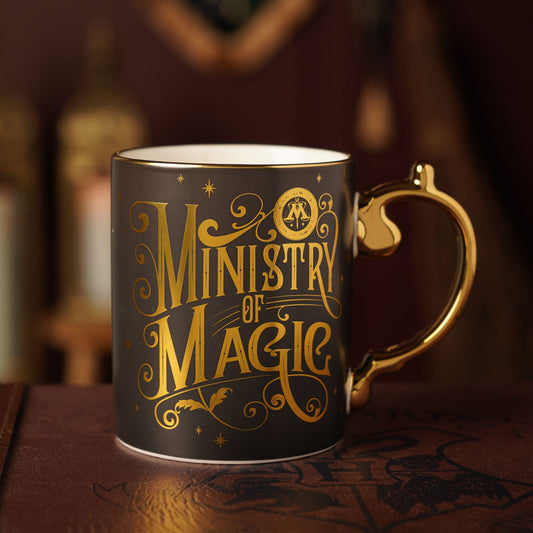 Ministry of Magic themed ceramic mug with gold handle and dark gray body