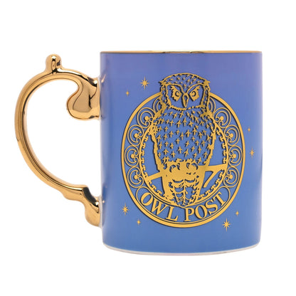 Blue ceramic mug with owl emblem and Owl Post text, gold handle.