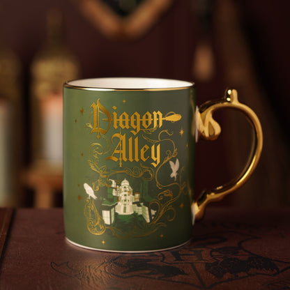 Green ceramic mug with gold handle, Diagon Alley graphic and lettering on front