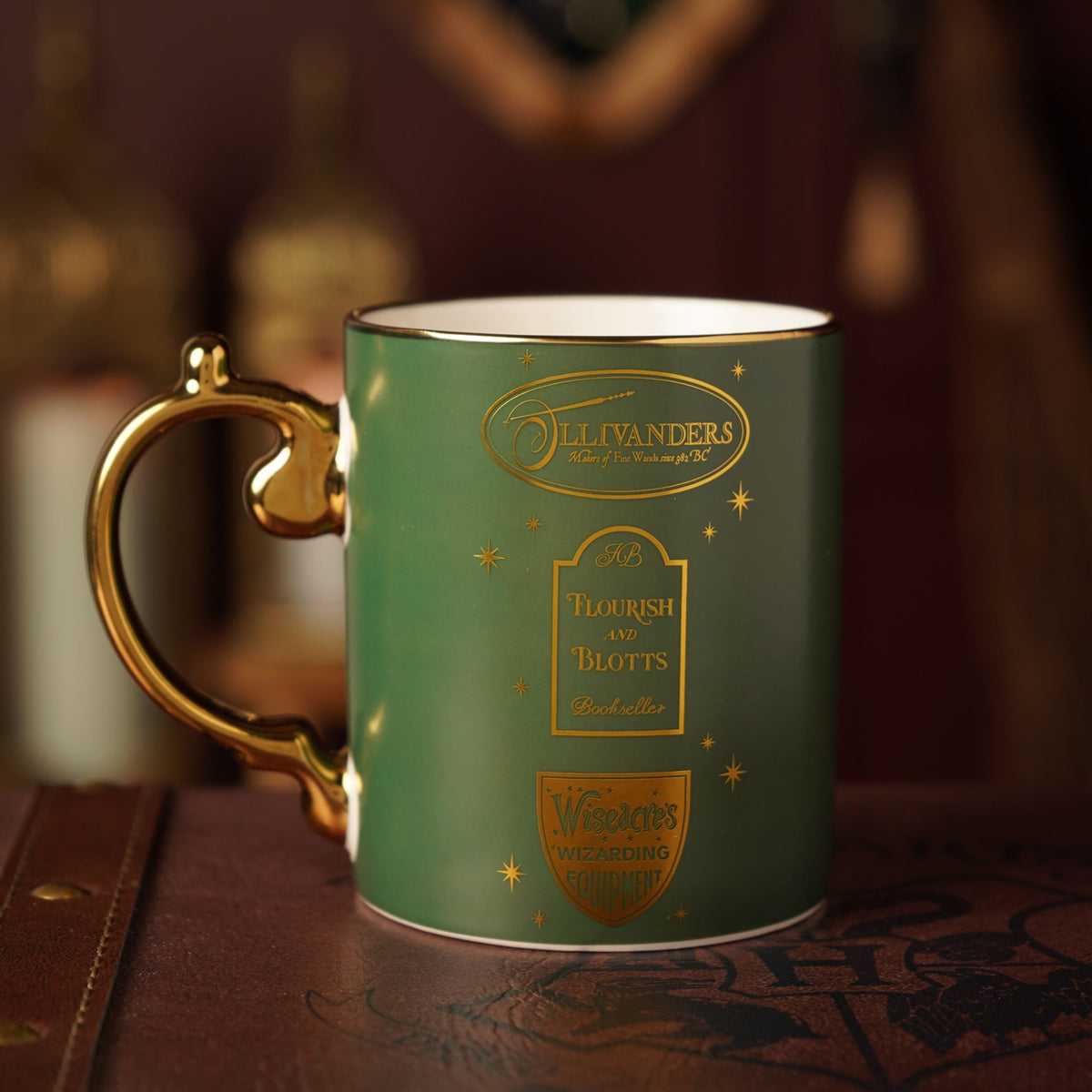 Green ceramic mug with gold handle, Ollivanders crest and text on front