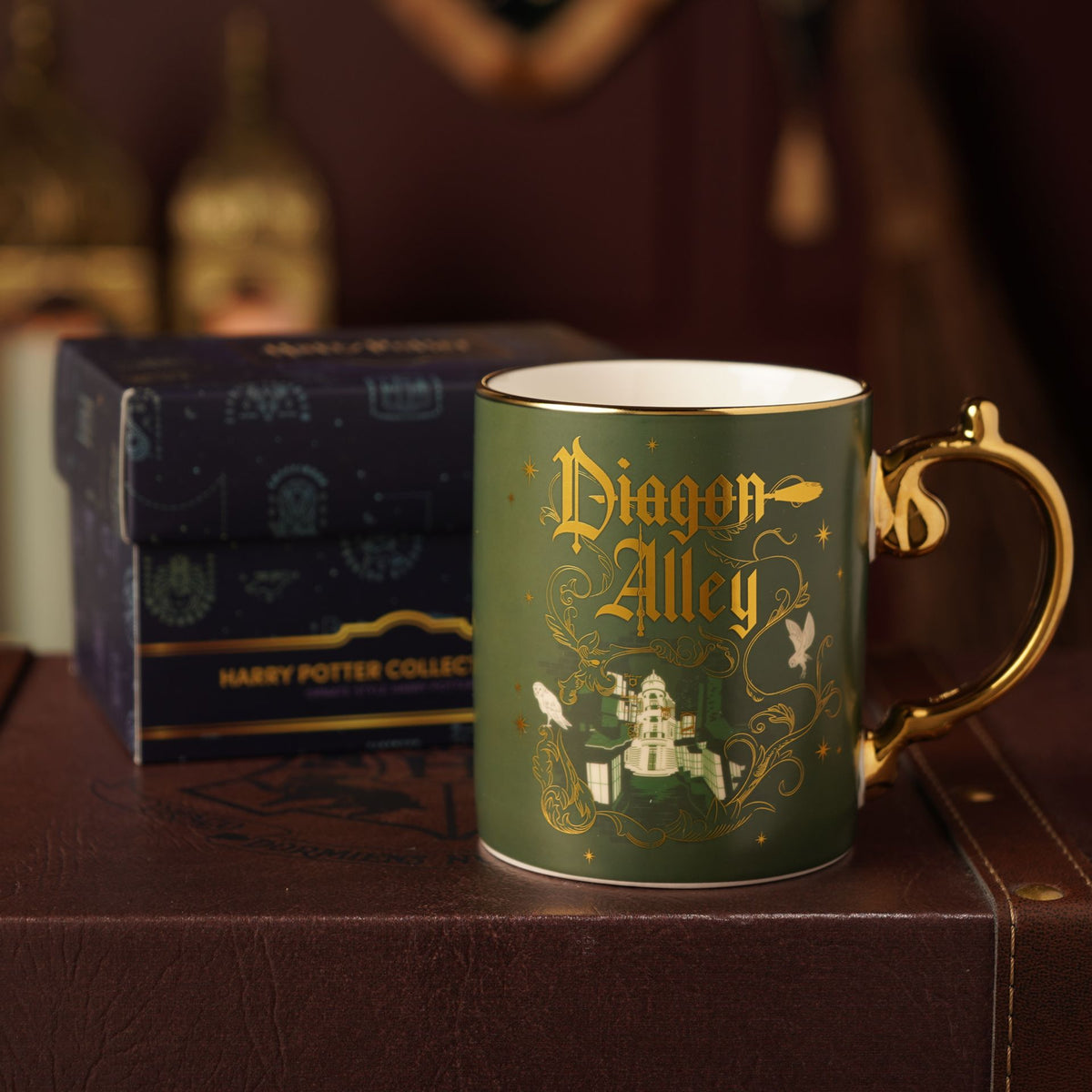 Green ceramic mug with gold handle, Diagon Alley graphic and castle illustration