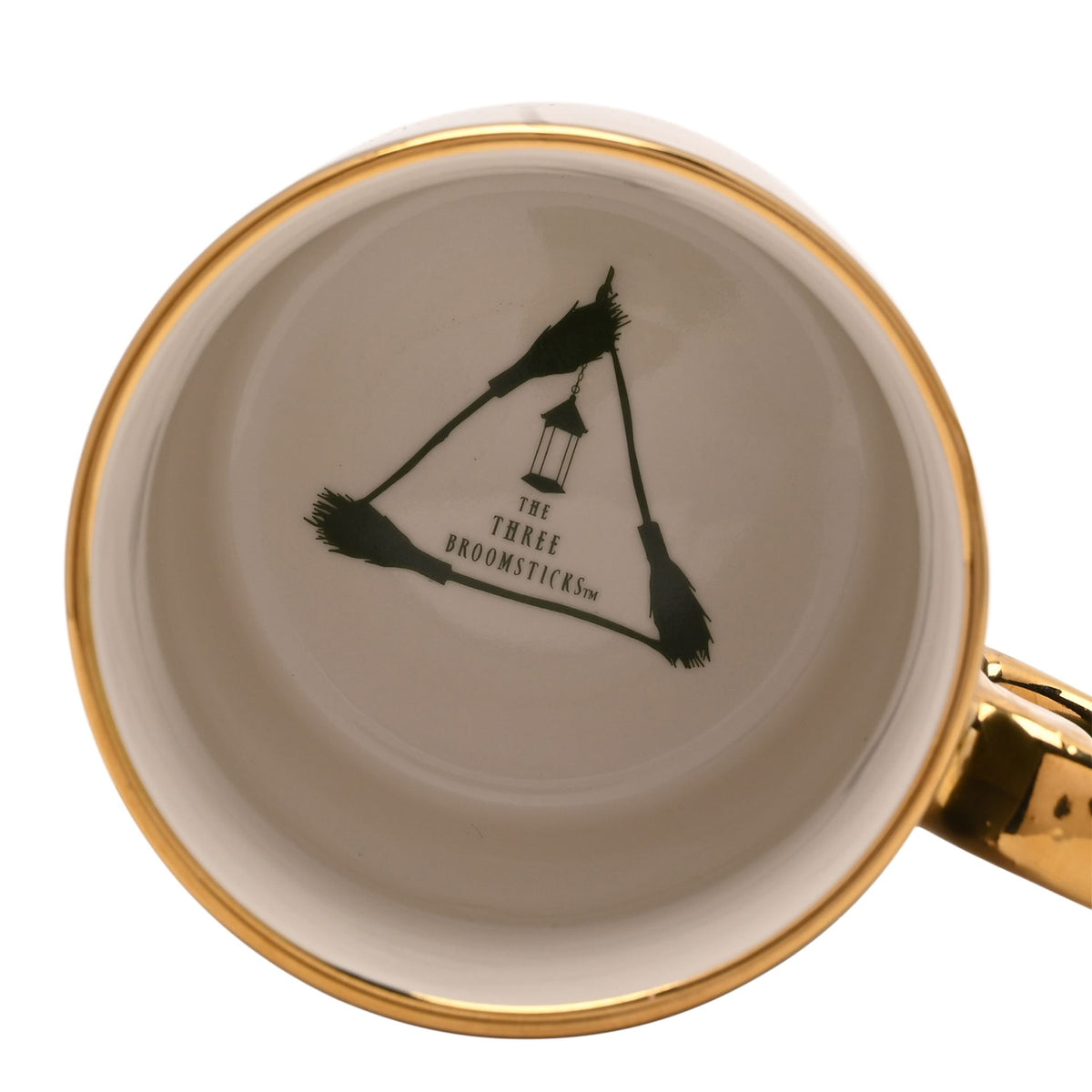 Mug interior with gold rim, black broom emblem and 'Three Broomsticks' text