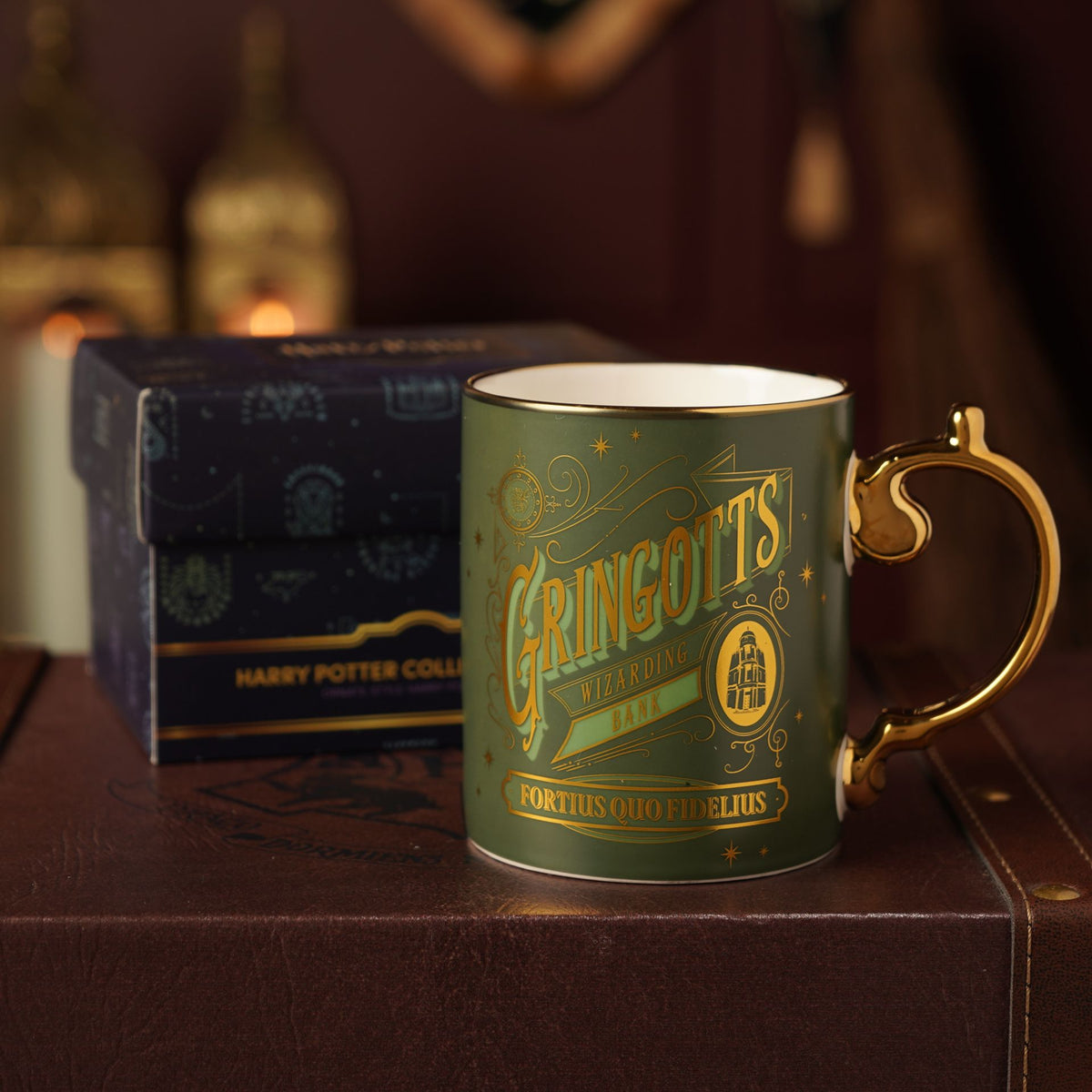 Green Gringotts collectible mug with gold handle and wizarding bank artwork; box behind