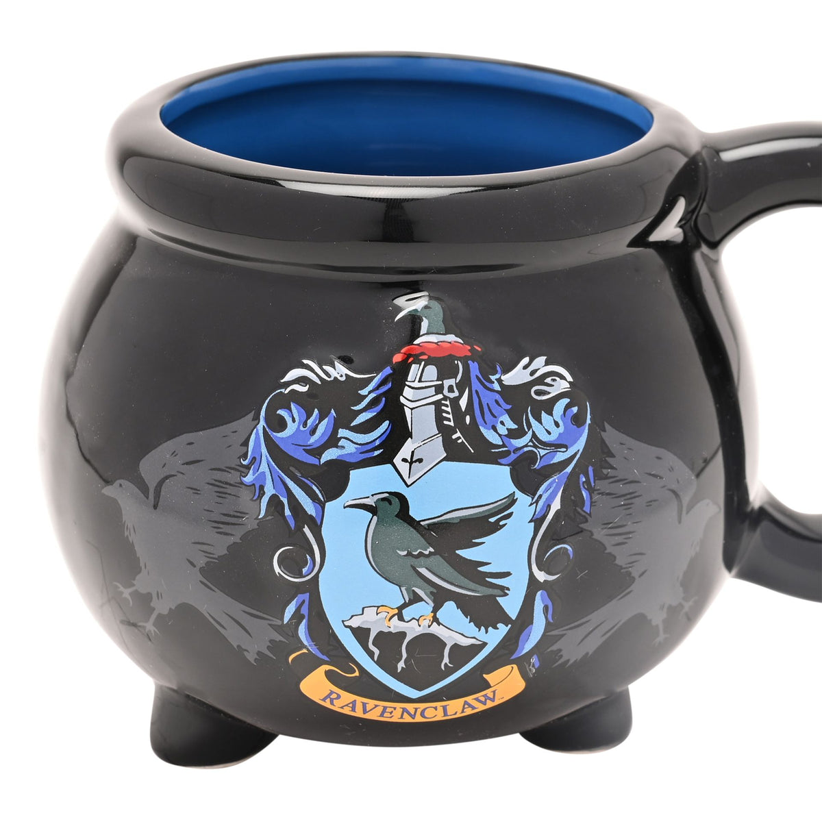 Close-up of black Ravenclaw cauldron mug with blue interior and crest